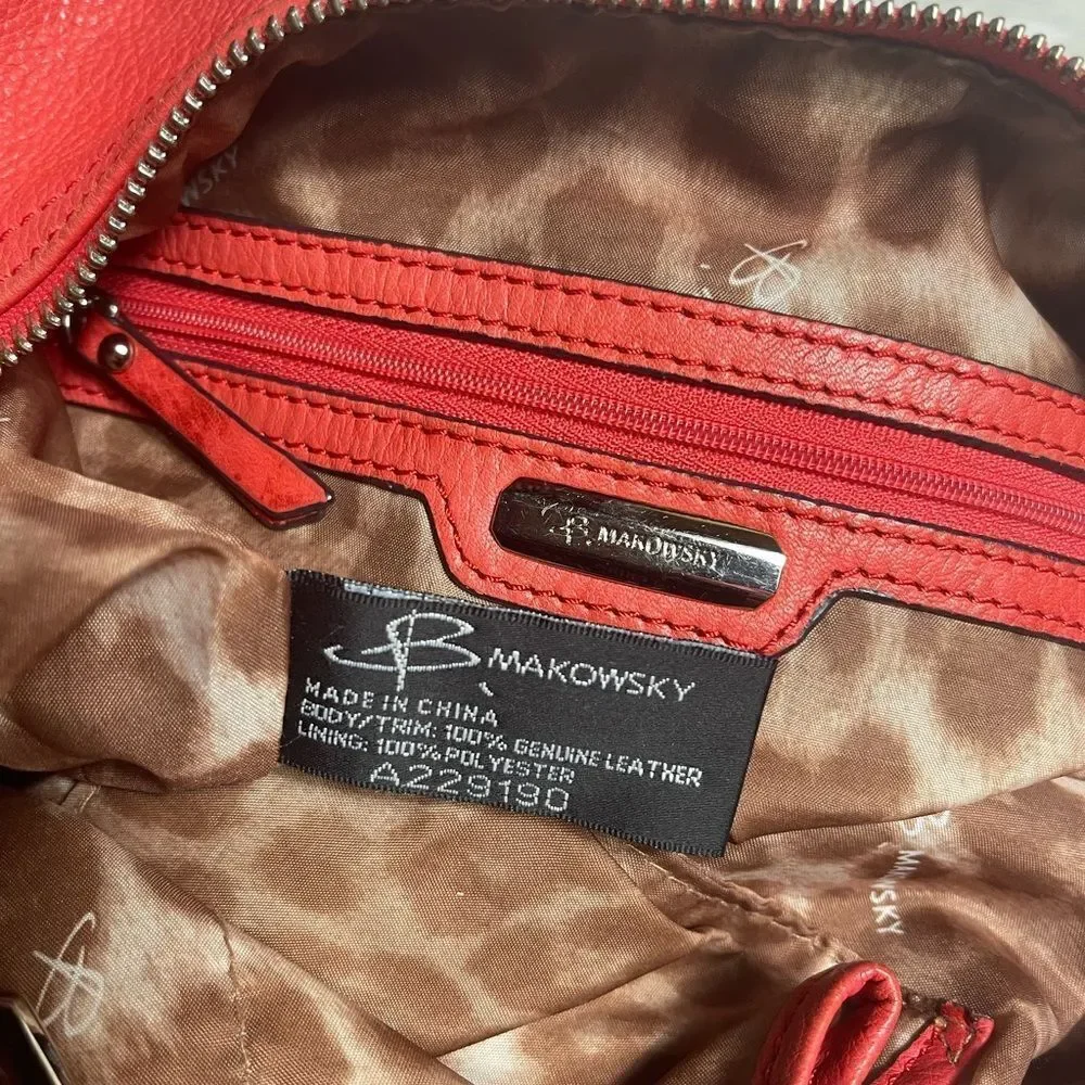 B Makowsky leather orange Hobo bucket style shoulder bag  silver tone hardwares